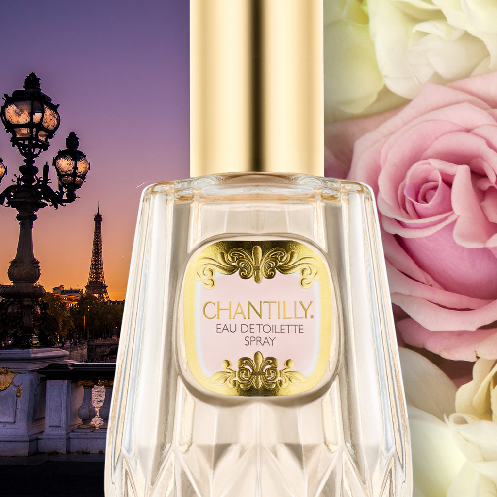 Editorial shot: close-up of a bottle of Chantilly eau de toilette spray on a background of a view of Paris at sunset and and giant  roses.