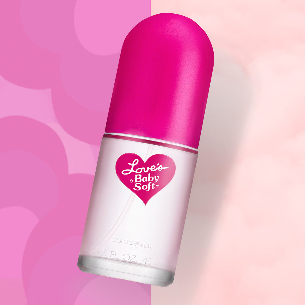 Editorial shot of a bottle of Love's Baby Soft cologne mist on a fun pink background.